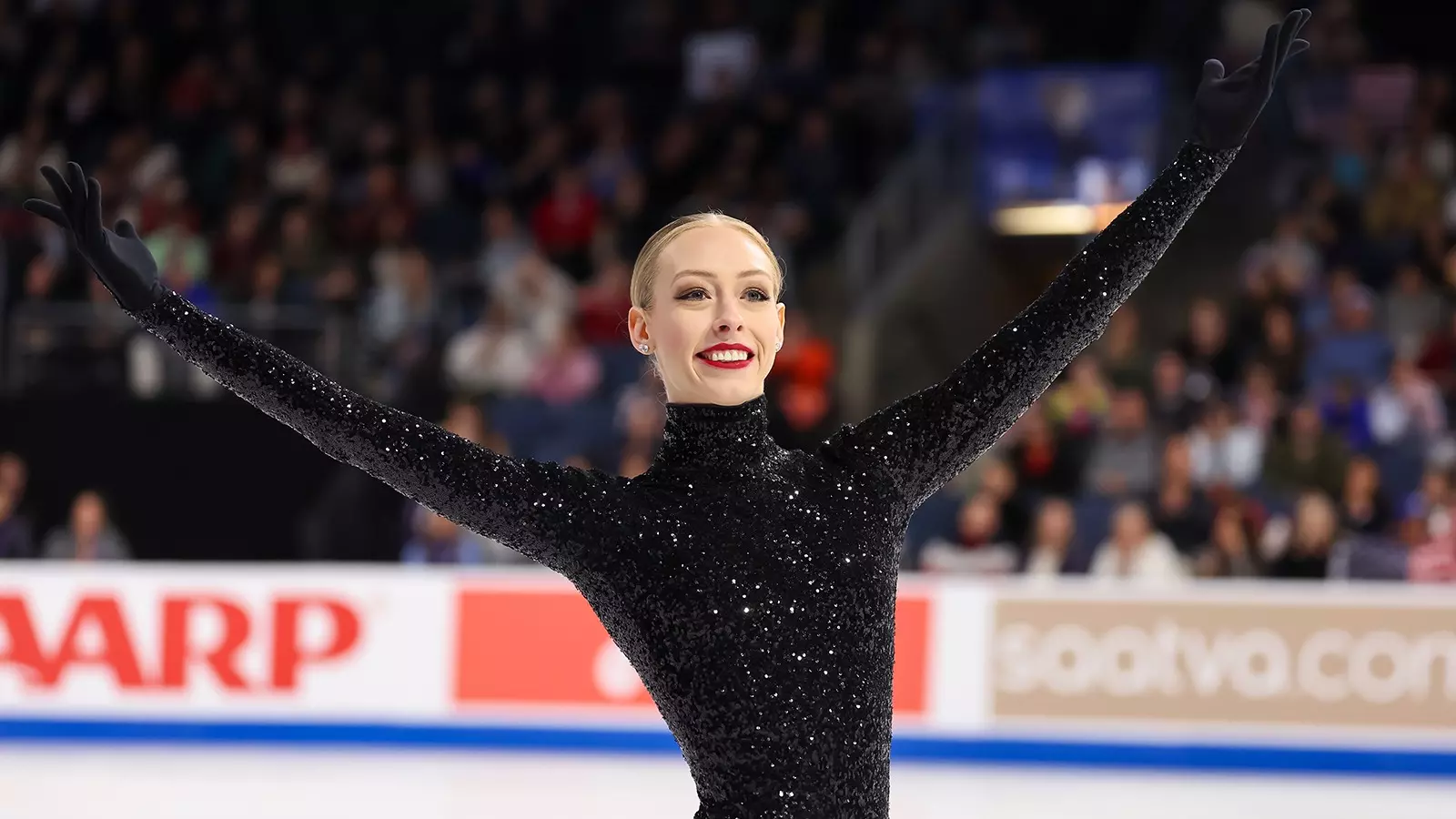 Bradie Tennell celebrating on the ice with arms raised in victory